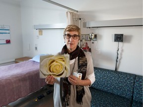 Deb Kirkpatrick, chaplain at Misericordia Community Hospital, with a sign that hospital staff use to denote a terminal patient's final part of life in one of five new compassion rooms on Thursday, Feb. 14, 2019.