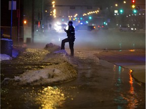 A police officer works at the scene of a huge 109 Street and 104 Avenue in Edmonton on Friday, Feb. 15, 2019.