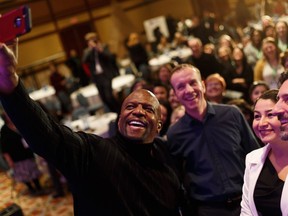 Terry Crews take a selfie with conference attendees during the Leading Change Summit 2019 at River Cree Resort and Casino in Edmonton, on Wednesday, Feb. 20, 2019.