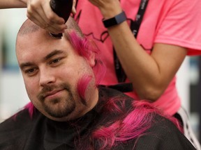 Mel Campbell from The Cutting Room shears Matt's pink hair during the 17th annual Hair Massacure held in support of the Children's Wish Foundation and Terry Fox PROFYLE charities, at West Edmonton Mall in Edmonton, on Friday, Feb. 22, 2019.