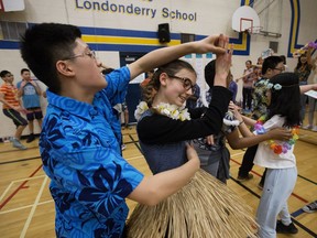 Grade 8 students Logan Hall, 13, and Scarlett Hunter, 13, dance the Two Step with their class during the annual Londonderry School Social Dance Contest, in Edmonton Friday Feb. 22, 2019. Over 700 Grade 7-9 students took part in the contest which is the culmination of their Social Dance course.