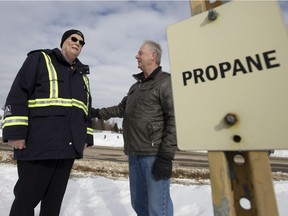 Burn survivor Peter Clark, left, and retired Edmonton firefighter Barry Lamb chat along a propane pipeline in Mill Woods near 12 Avenue and 40 Street in Edmonton on Wednesday Feb. 27, 2019.