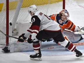 Arizona Coyotes Vinnie Hinostroza (13) scores the winning goal on Edmonton Oilers goalie Mikko Koskinen (19) in the shootout during NHL action at Rogers Place in Edmonton, Feb. 19, 2019.