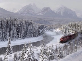 A Canadian Pacific freight train travels around Morant's Curve near Baker Creek, Alta. on Monday, December 1, 2014. A feasibility study released today says bus or passenger rail service between Calgary and Banff National Park would make sense. THE CANADIAN PRESS/Frank Gunn ORG XMIT: CPT139