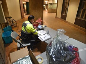 A peace officer sits at a reception table as the city has opened the Central LRT station for the homeless during a blast of cold weather in Edmonton on Wednesday, Feb. 6, 2019.