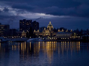 The British Columbia Legislature is reflected in the waters of Victoria harbour in the early morning in Victoria, B.C. File photo.