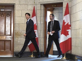 Prime Minister Justin Trudeau leaves his office with his principal secretary Gerald Butts to attend an emergency cabinet meeting on Parliament Hill in Ottawa on Tuesday, April 10, 2018. Butts has resigned amid allegations that the Prime Minister's Office interfered to prevent criminal prosecution of SNC-Lavalin.