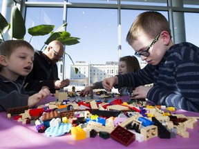 Ilija Renic, 6, left, his father Tom Renic, sister Jelena Renic, 7, and brother Karlo Renic, 9, take part in the Family Day activities in the Lego zone at the Edmonton Federal building on Monday, Feb. 18, 2019, in Edmonton. (Greg Southam-Postmedia)