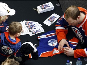 The Edmonton Oilers defenceman  Jim Vandermeer signs an unidentified fans jersery at West Edmonton Mall in Edmonton on Feb. 20, 2011.