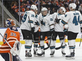 San Jose Sharks celebrate a goal as Edmonton Oilers goalie Cam Talbot (33) looks on during first period NHL action in Edmonton on Saturday, Feb. 9, 2019.