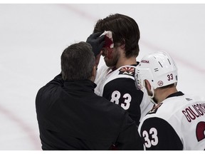 Arizona Coyotes Conor Garland is help after getting hit in the head and scoring on the Edmonton Oilers during second period NHL action on Saturday, Jan. 12, 2019 in Edmonton.