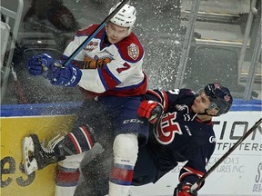 Edmonton Oil Kings Parker Gavlas (left) is checked into the boards by Lethbridge Hurricanes Scott Mahovlich during first period WHL hockey game action in Edmonton on Sunday January 6, 2018.