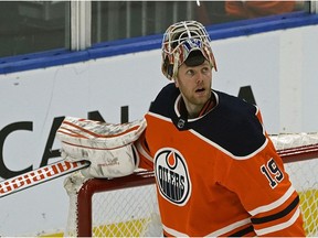 Edmonton Oilers goalie Mikko Koskinen looks up at the clock during third-period action against the Detroit Red Wings in Edmonton on Tuesday, Jan. 22, 2019.