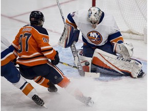 Edmonton Oilers Connor McDavid (97) can't score on New York Islanders goalie Christopher Gibson (33) during second period NHL action on Thursday, March 8, 2018 in Edmonton.