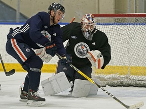 Edmonton Oilers captain Connor McDavid skates past goalie Mikko Koskinen during team practice in Edmonton on Tuesday February 12, 2019.