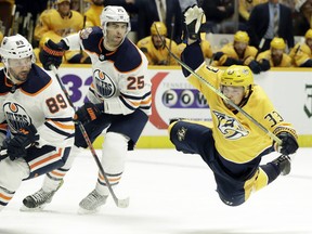 Nashville Predators left wing Viktor Arvidsson (33) falls after being tripped by Edmonton Oilers forward Sam Gagner (89) in the second period of an NHL hockey game Monday, Feb. 25, 2019, in Nashville, Tenn.