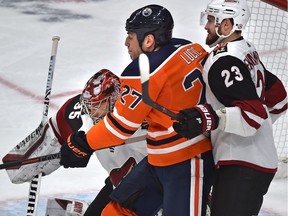 Edmonton Oilers Milan Lucic (27) gets pushed around by Arizona Coyotes Oliver Ekman-Larsson (23) in front of goalie Darcy Kuemper (35) during NHL action at Rogers Place in Edmonton, Feb. 19, 2019.