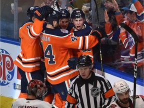 Edmonton Oilers Ryan Nugent-Hopkins (R) celebrates his tying goal with 11 seconds left with teammates against the Arizona Coyotes during NHL action at Rogers Place in Edmonton, February 19, 2019.