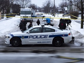 Police and media are seen near a house where a young girl was found dead in Brampton, Ont. on Friday, February 15, 2019. The father of an 11-year-old girl allegedly killed while out celebrating her birthday is in police custody and will soon be facing charges in his daughter's death, officers said Friday. Peel regional police Const. Danny Marttini said Roopesh Rajkumar is en route back to Brampton, Ont., the suburb west of Toronto where his daughter Riya was found dead late Thursday night.