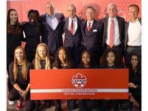 Canadian Soccer Association executives and coaches pose with players from Ontario's regional EXCEL Centre after the CSA unveiled its 2019-21 strategic plan at a BMO Field news conference in Toronto on Monday, Feb.11, 2019. From left to right with the players are Canadian Soccer Association director of development Jason deVos, CSA general secretary Peter Montopoli, CSA vice-president Nick Bontis, CSA president Steven Reed Canadian women's coach Kenneth Heiner-Moller and Canadian men's coach John Herdman.