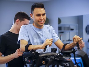 Dr. Richi Gill, in grey shirt, a Calgary doctor, takes part in physiotherapy in Calgary, Alta., Wednesday, Feb. 13, 2019. Dr. Richi Gill's life changed in an instant. The 38-year-old surgeon, who helped develop Calgary's bariatric surgery program, was involved in a freak accident on a boogie board during a family vacation in Hawaii one year ago.