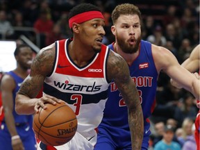 Washington Wizards guard Bradley Beal (3) drives around Detroit Pistons forward Blake Griffin (23) during the second half of an NBA basketball game on Feb. 11, 2019, in Detroit.