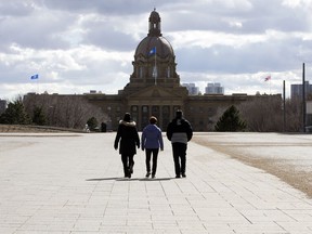 Pedestrians walk through the plaza outside the Federal Building on the Alberta legislature grounds, in Edmonton on April 3, 2017.