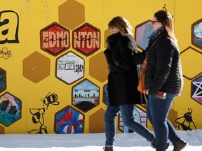 People walk past an art wall at Churchill Square on a warm winter day in Edmonton, on Thursday, Jan. 28, 2019.