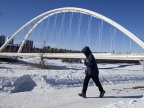 A jogger makes their way past the Walterdale Bridge, in Edmonton Monday March 4, 2019.