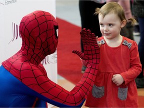 Bridgette Suvan, 3, high-fives Spider-Man during a news conference on Thursday, March 7, 2019, where the Telus World of Science announced that the Marvel: Universe of Super Heroes exhibit is coming to the science centre in October.