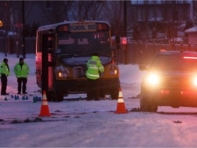 Edmonton Police Service officers investigate after two teenage girls from Bessie Nichols school were sent to hospital after being struck by a school bus on Hemingway Road and 205 Street in Edmonton on Friday, March 8, 2019.