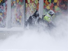 Crews clear snow near 80 Avenue and 104 Street, in Edmonton Friday March 8, 2019. Environment Canada issued a snowfall warning for the city of Edmonton Friday as forecasters warned of snowfall amounts of 10 to 20 cm.