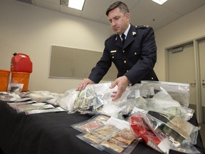 Insp. Eric Stebenne, operations officer at Wood Buffalo RCMP, shows reporters the drugs and money seized during a Wood Buffalo RCMP investigation that lead to drug busts in Fort McMurray and Edmonton in Sherwood Park Friday, March 8, 2019. Police seized drugs with a street value of more than $800,000 and approximately $30,000 in cash.