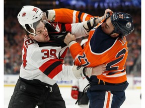 Edmonton Oilers' Milan Lucic (27) fights New Jersey Devils' Kurtis Gabriel (39) during the first period of a NHL game at Rogers Place in Edmonton, on Wednesday, March 13, 2019.