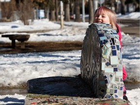 Charley Charest, 6, plays around a community built art bench outside of Holyrood School in Edmonton, on Friday, March 15, 2019.
