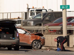 Edmonton Police Service officers investigate after a crash invovling a police cruiser and a stolen Hyundai Tucson on Yellowhead Highway east of 66 Street in Edmonton, on Wednesday, March 20, 2019.