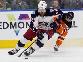 The Edmonton Oilers' Joseph Gambardella (45) chases the Columbus Blue Jackets' David Savard (58) during first period NHL action at Rogers Place, in Edmonton Thursday March 21, 2019.