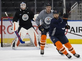 Alex Petrovic (15) and Zack Kassian (44) take part in an Edmonton Oilers practice at Rogers Place, in Edmonton Monday March 25, 2019.