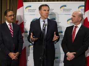 Federal Finance Minister Bill Morneau speaks to the media following a speech to the Edmonton Chamber of Commerce about 2019 Federal Budget, in Edmonton Wednesday March 27, 2019. Minister of Natural Resources Amarjeet Sohi (left) and Edmonton Centre MP Randy Boissonnault are pictured with Morneau. Photo by David Bloom