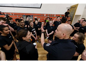 Cst. Karyn Chikhacheva (bottom left) and Cst. Joe Elias lead a drill during the fifth annual EPS Youth Recruit Academy at M.E. LaZerte High School in Edmonton, on Thursday, March 28, 2019. Forty high school students experienced what it is like to be a police officer during the event. Photo by Ian Kucerak/Postmedia