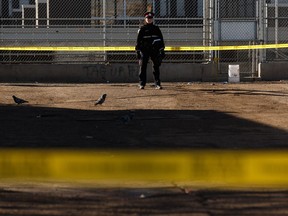 Edmonton Police Service officers conduct an investigation in a parking lot next to the George Spady Centre after a woman died in a stabbing in Edmonton, on Thursday, March 28, 2019.