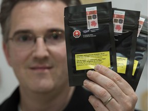 Rob Cherry, vice-president and general merchandise manager at Fire and Flower, holds packages of cannabis seeds at the Fire and Flower location in Sherwood Park on Thursday, March 28, 2019.