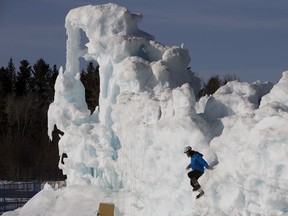 A crew member climbs down from the Ice Castle in Hawrelak Park, as lights and electrical are removed prior to the demolition of the structure, in Edmonton Thursday March 28, 2019.