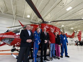 A group photo with STARS staff, President and CEO Andrea Robertson, survivor Brian Smith, Minister of Public Safety and Emergency Preparedness Ralph Goodale, Minister of Natural Resources Amarjeet Sohi and MP for Edmonton Centre Randy Boissonnault are seen during a press conference at STARS Edmonton Base at Edmonton International Airport in Nisku, on Friday, March 29, 2019. The federal government is spending $65 million to fund five of nine new, modern helicopters to update the rescue service's fleet.