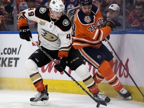 The Edmonton Oilers' Kyle Brodziak (28) battles the Anaheim Ducks' Max Jones (49) during first period NHL action at Rogers Place, in Edmonton Saturday March 30, 2019. Photo by David Bloom