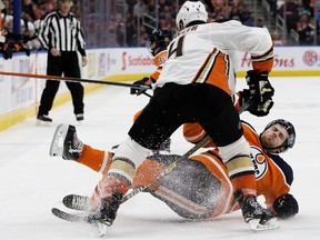 The Edmonton Oilers' Leon Draisaitl (29) is brought down by the Anaheim Ducks' Cam Fowler (4) during second period NHL action at Rogers Place, in Edmonton Saturday March 30, 2019.