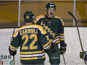 University of Alberta Golden Bears forward Luke Philp celebrates his goal with teammate Ben Carroll against the University of Calgary Dinos during Canada West semi-final game 2 action on Saturday February 25, 2017 at Clare Drake Arena in Edmonton.