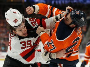 Edmonton Oilers' Milan Lucic (27) fights New Jersey Devils' Kurtis Gabriel (39) during the first period of a NHL game at Rogers Place in Edmonton, on Wednesday, March 13, 2019.