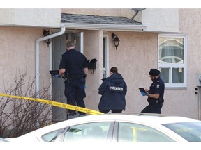 An Edmonton police forensic team investigates a suspicious death outside a home in the Lakewood Village neighbourhood on Saturday, March 23, 2019.