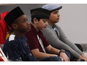 Children listen to prayers at Edmonton's Al Hadi Mosque on Saturday, March 23, 2019.